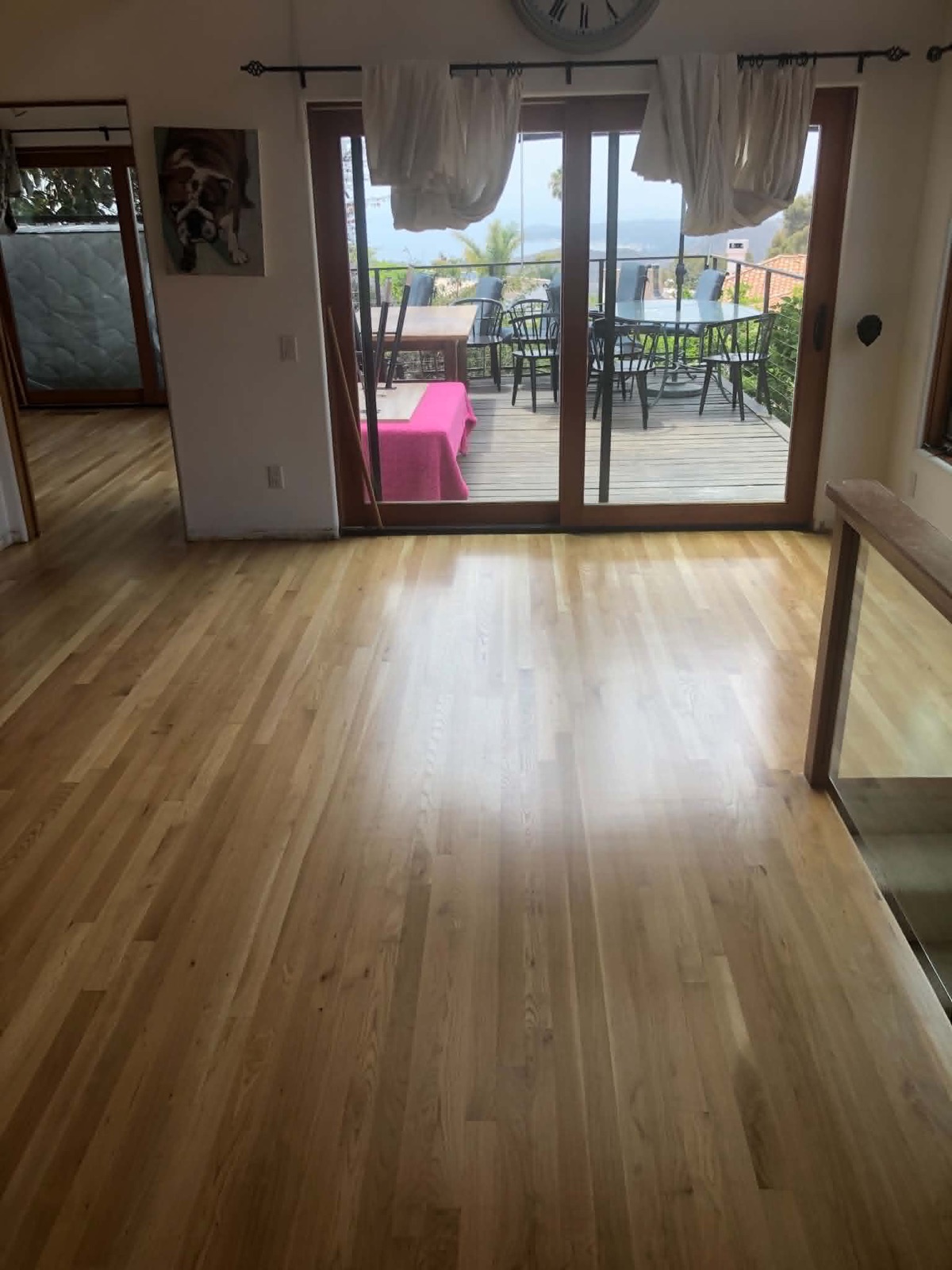 Living room with a natural light oak floor and an ocean-view balcony